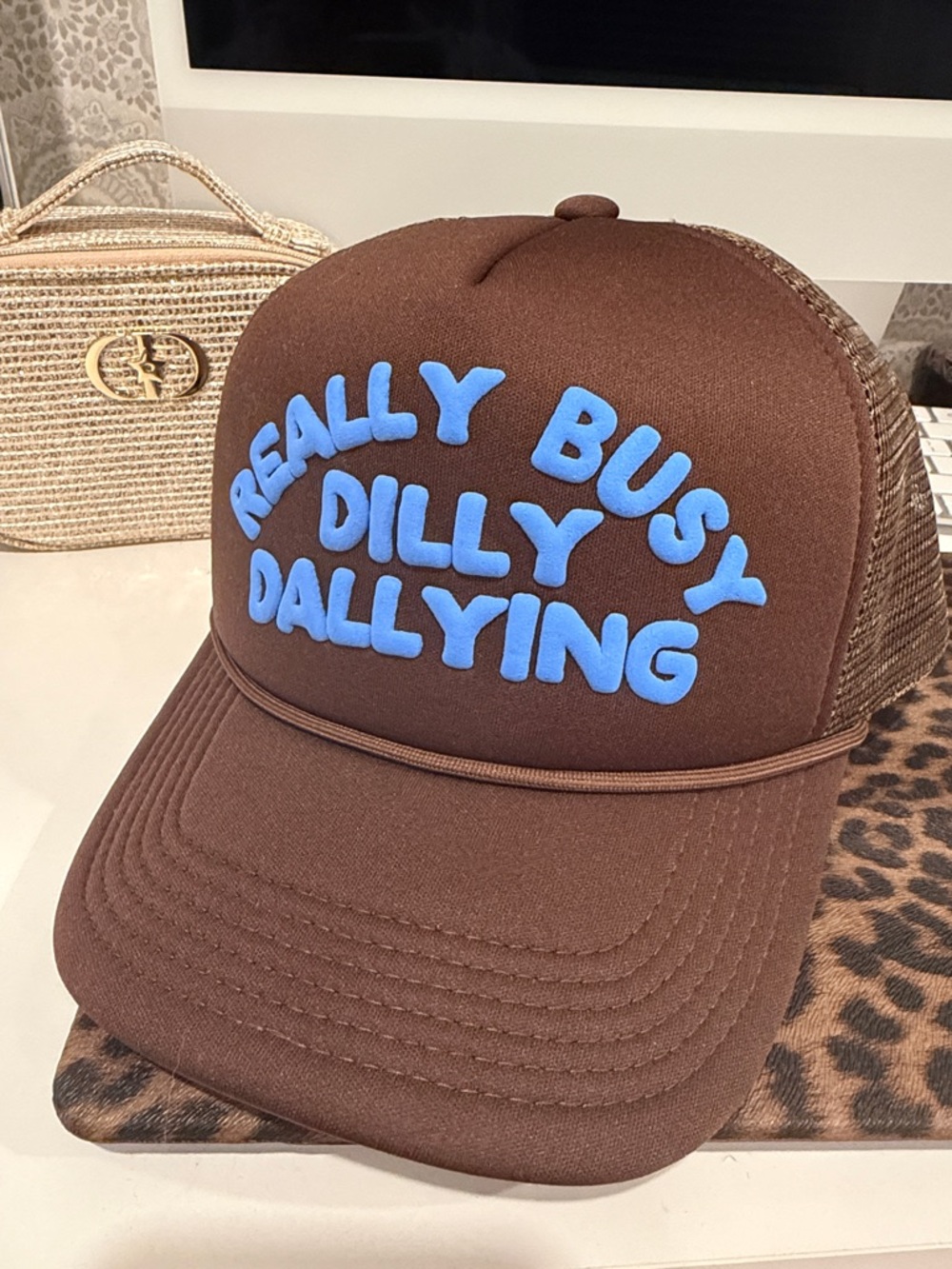 Brown Foam Trucker Hat with Blue 'Really Busy Dilly Dallying' Text